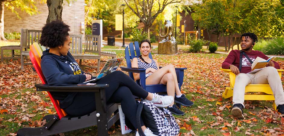 MCLA campus students sitting outdoors