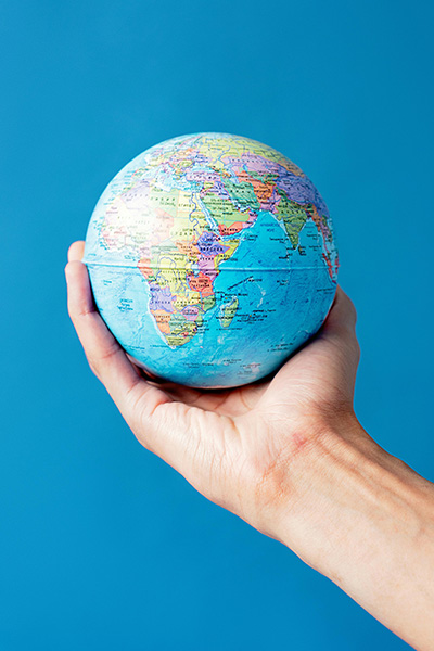 Hand holding a globe