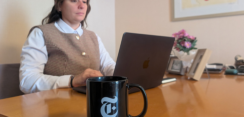 Jen Thomas sitting at her desk