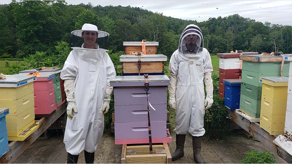 Two MCLA students in full beekeeping gear