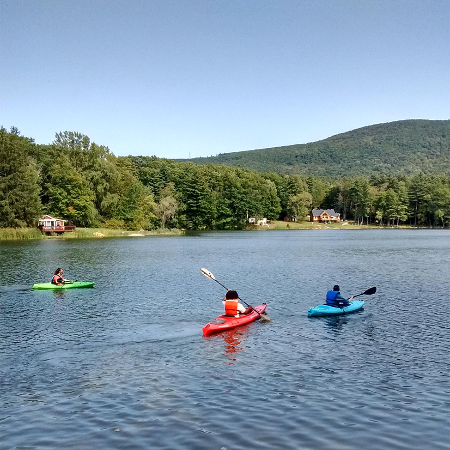 Environmental students kayak at a lake