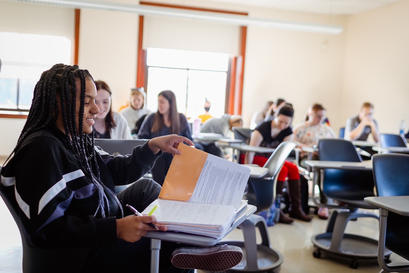 young female student studying in class. 