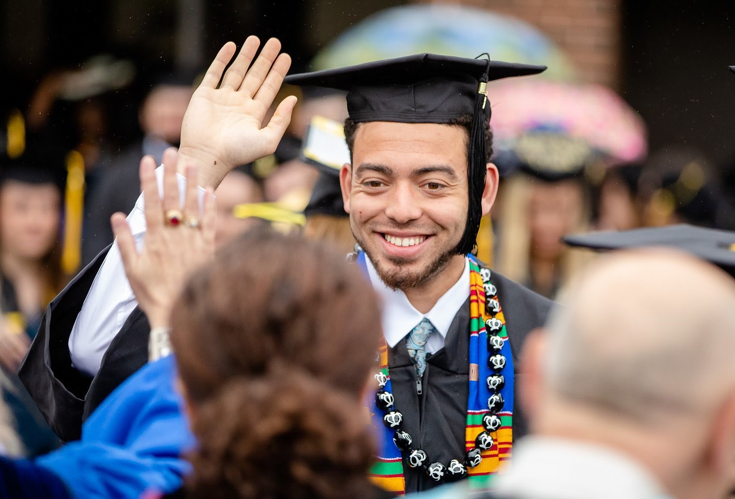 Graduating student giving a high-five