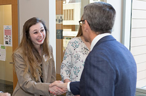 Student shaking hands with an employer