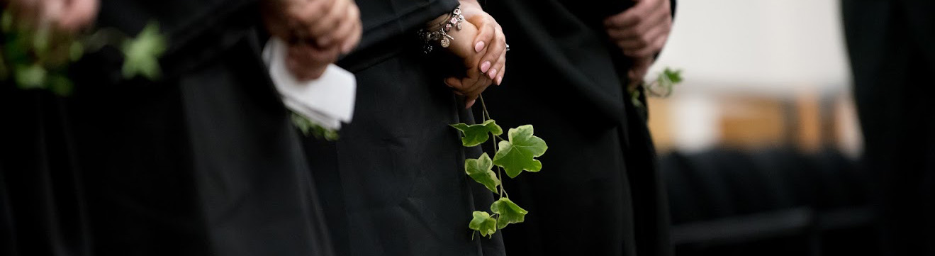graduates holding ivy