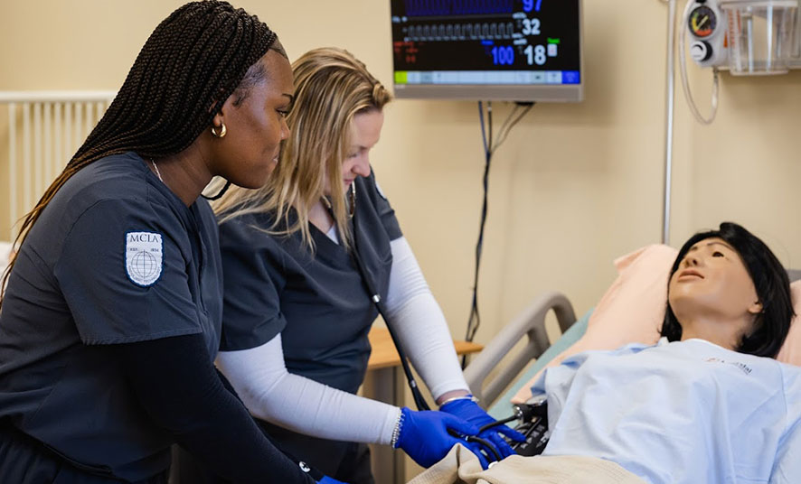 Nursing students examine patient.